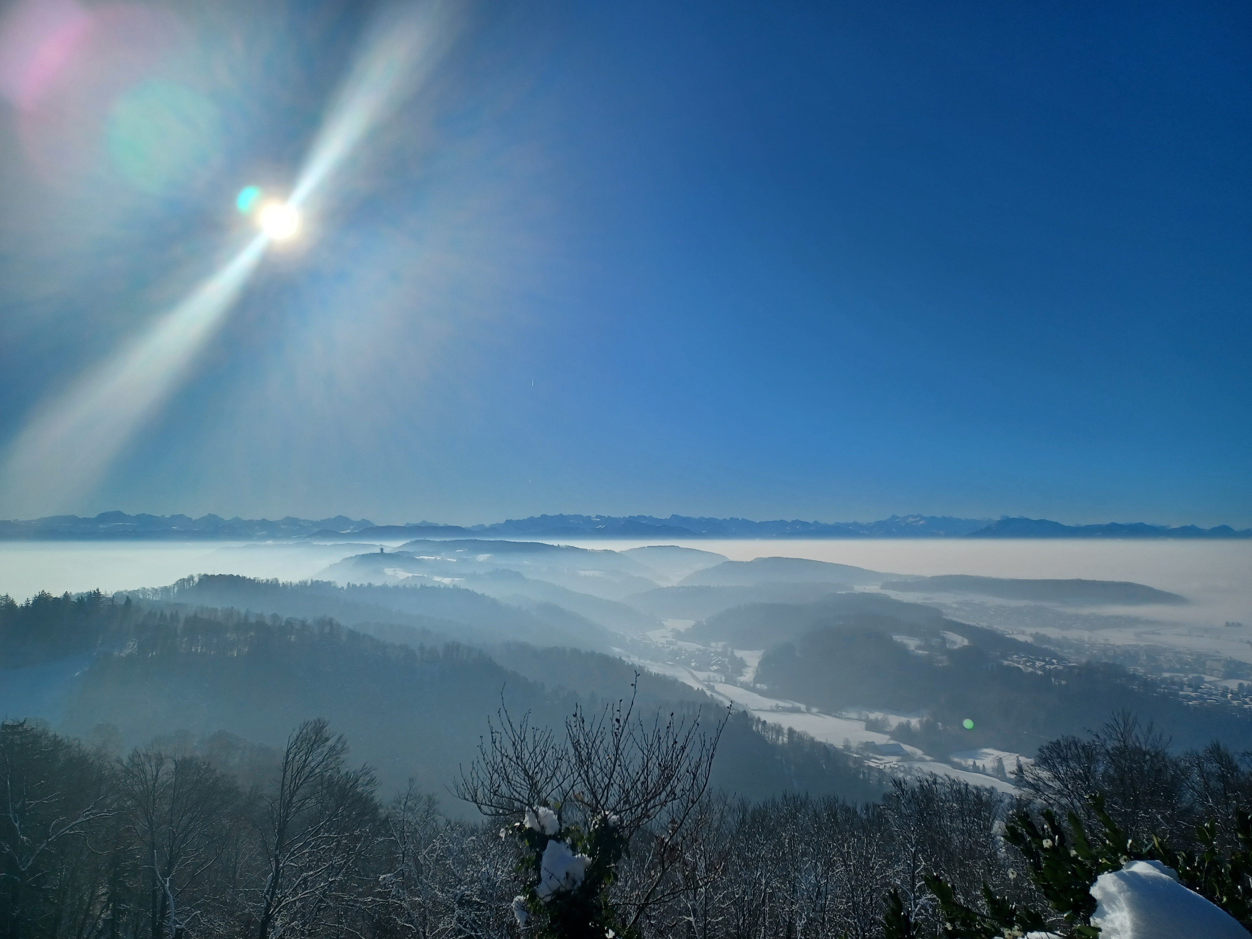 Alps with sun and low fog